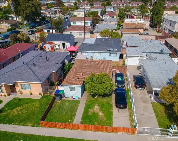 an aerial view of a houses with yard