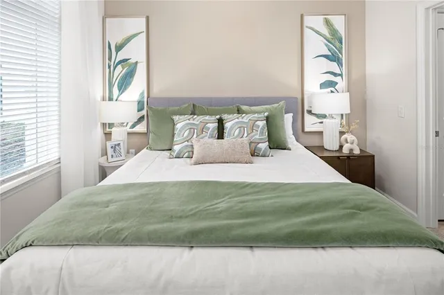 a bedroom with a bed and a window