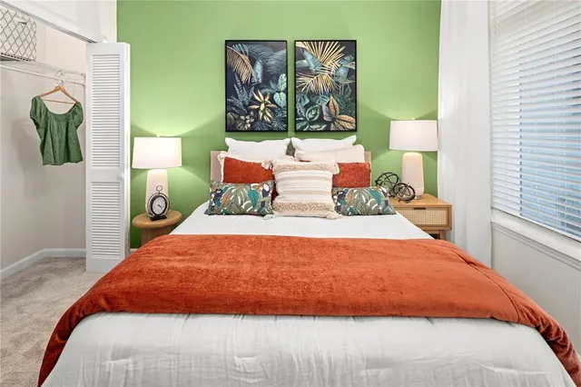 a bed sitting in a bedroom next to a window