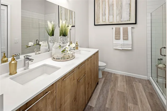 a bathroom with a sink a toilet and mirror