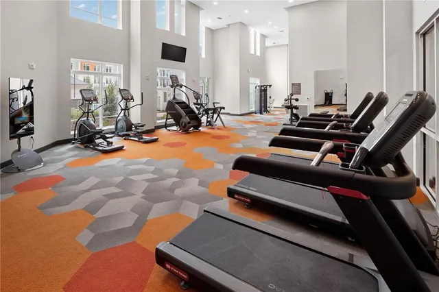 a room with gym equipment and a large window