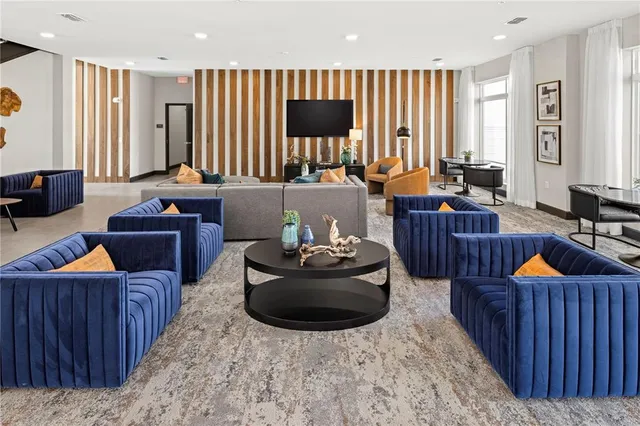 a living room with furniture and a lamp