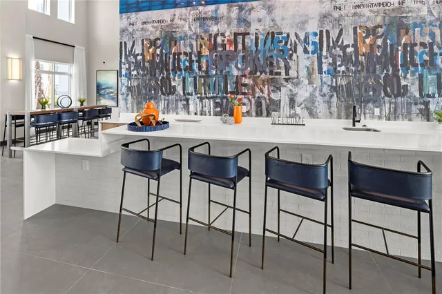a kitchen with a sink dining table and chairs