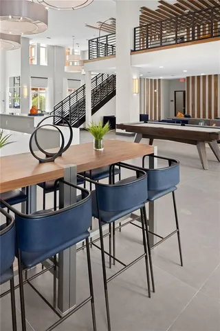 a room with musical instruments pool table and windows