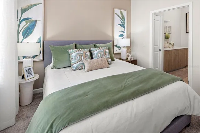 a bedroom with a bed and painting on the wall