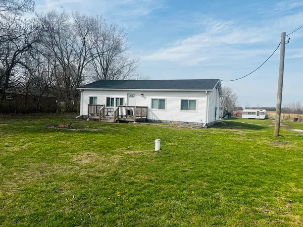 a front view of house with yard and green space