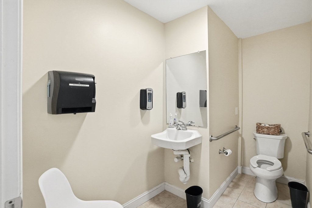 400-412 Neponset Avenue Boston, MA 02122 - Photo 29 of 31 a bathroom with a toilet a sink and mirror