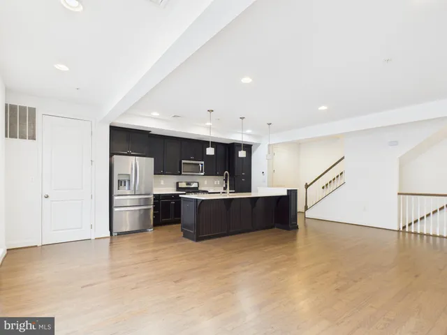 a living room with furniture and a kitchen