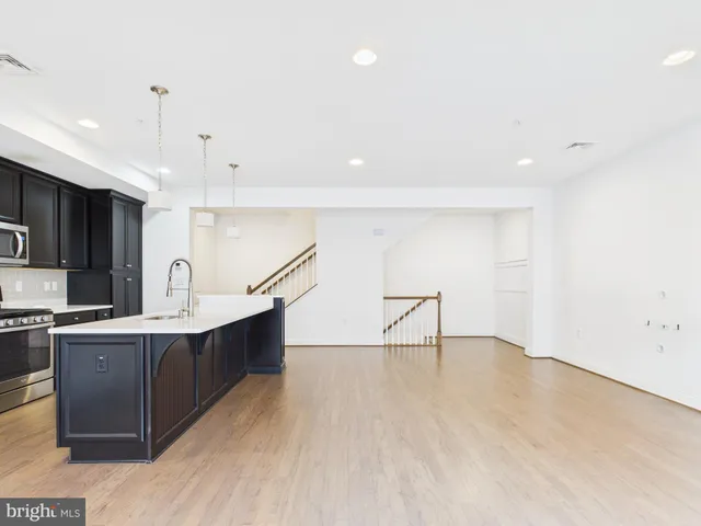 a view of kitchen with sink and wooden floor