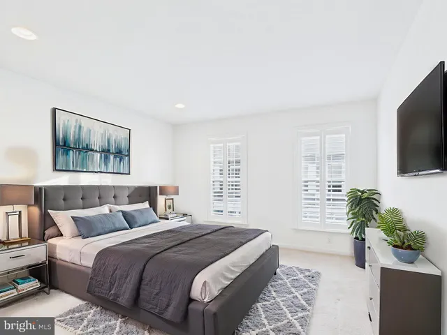 a bedroom with a large bed and a flat screen tv