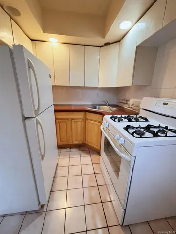 a kitchen with stainless steel appliances a refrigerator a sink and a stove