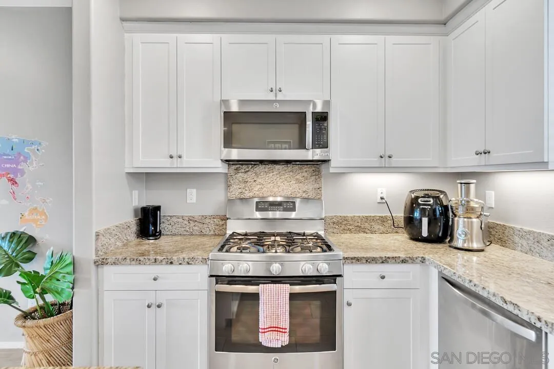 2840 Athens Road, Unit 10 Chula Vista, CA 91915 - Photo 4 of 35 a kitchen with granite countertop white cabinets and white appliances