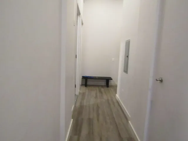 a view of a room with wooden floor