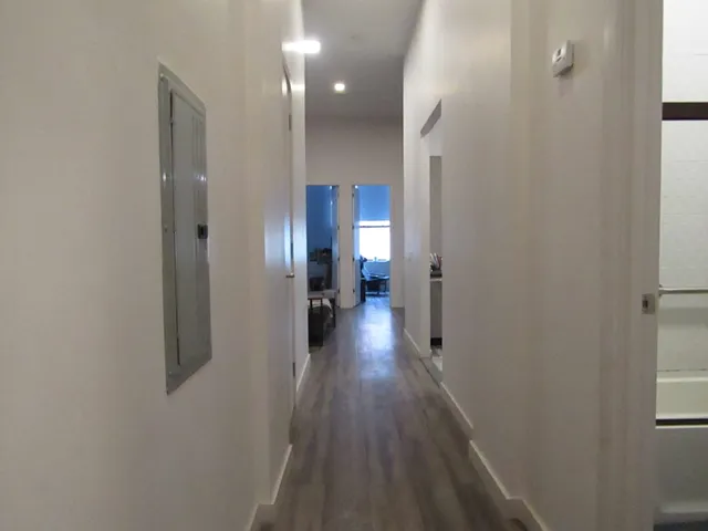 a view of hallway with wooden floor