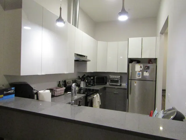 a kitchen with refrigerator and cabinets