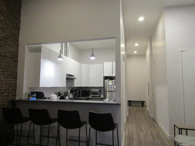 a kitchen with a sink cabinets and window