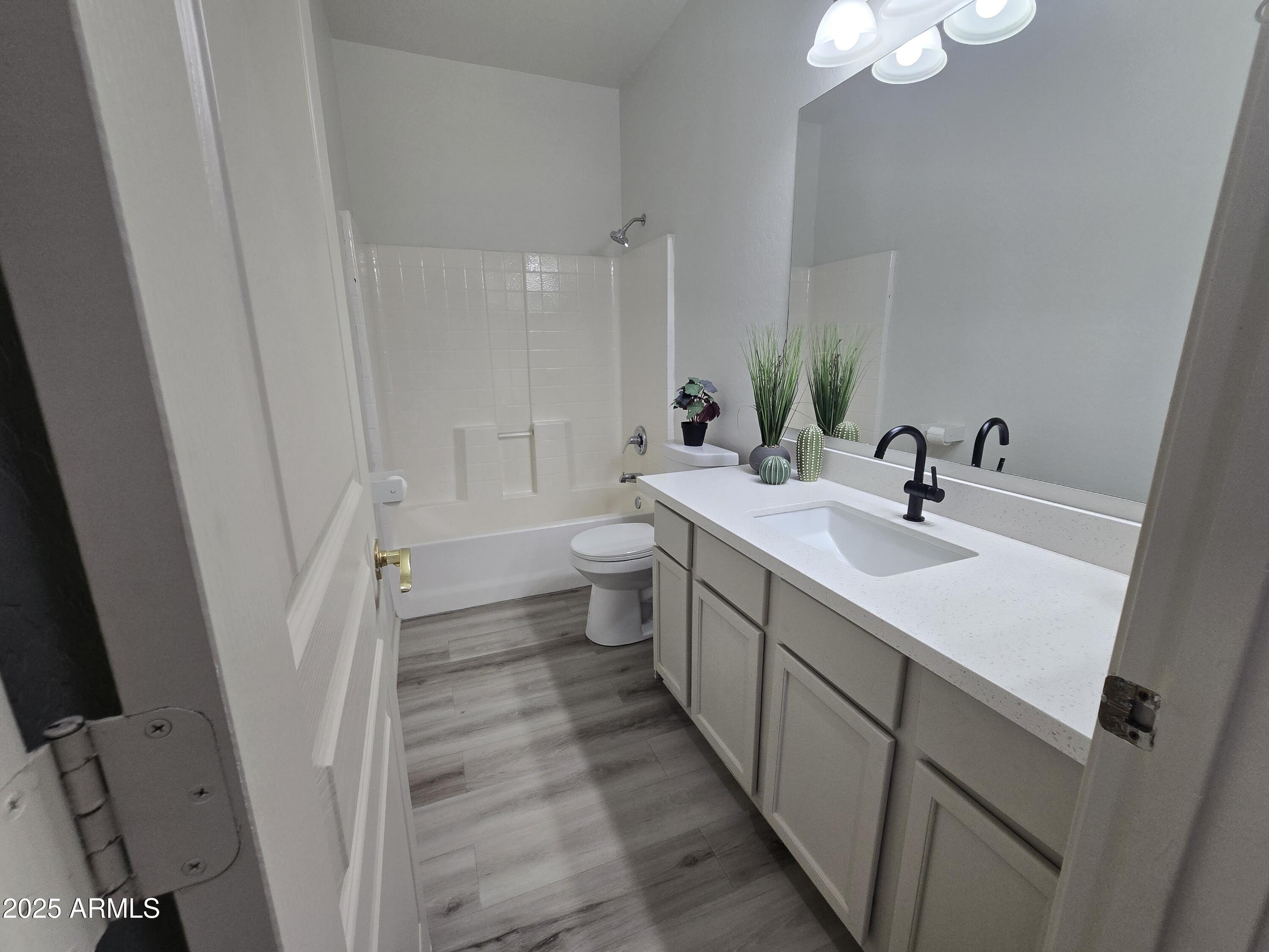 18196 Calacera Street Maricopa, AZ 85138 - Photo 12 of 21 a bathroom with a sink a toilet and a large mirror