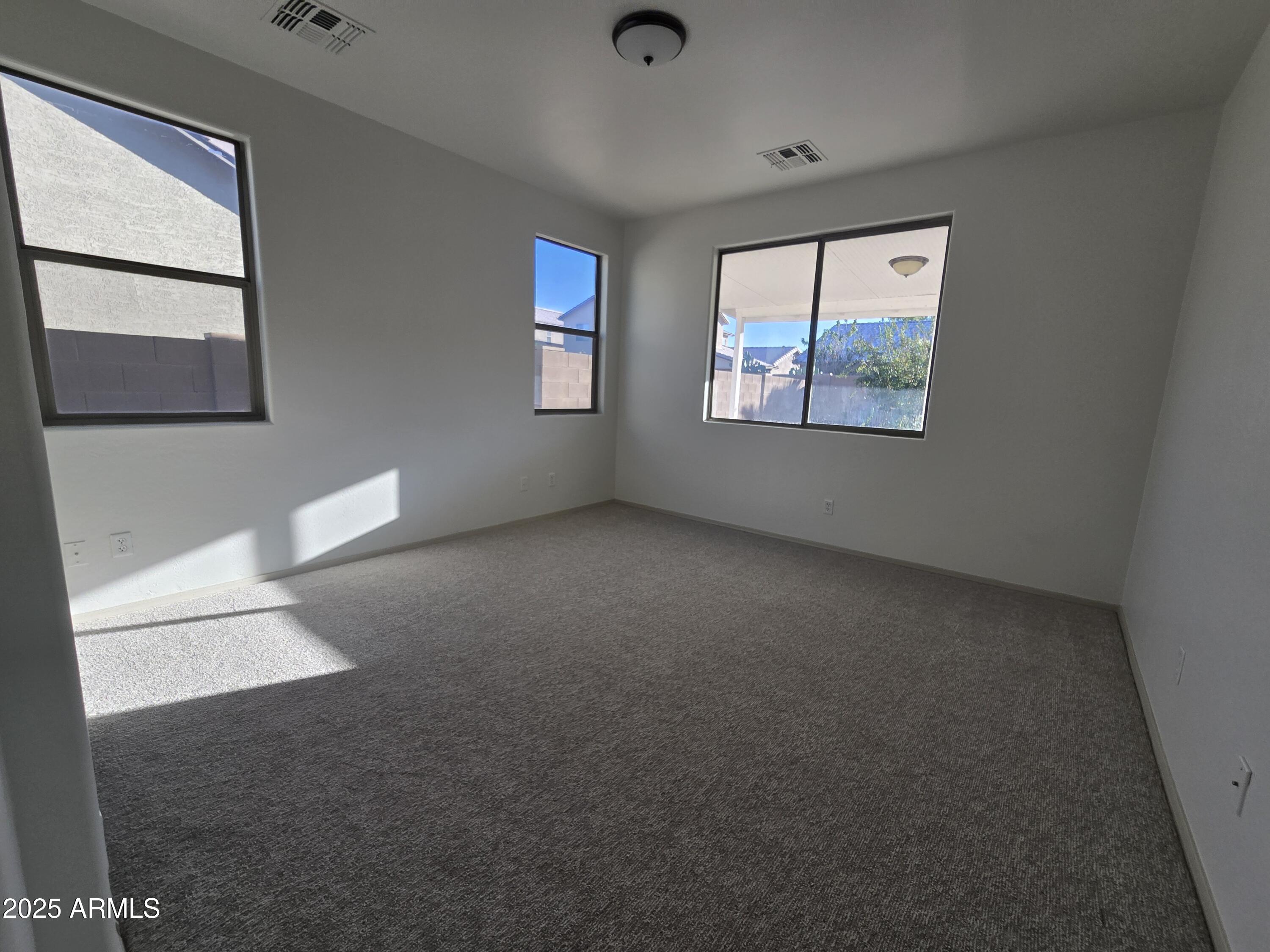 18196 Calacera Street Maricopa, AZ 85138 - Photo 13 of 21 an empty room with windows