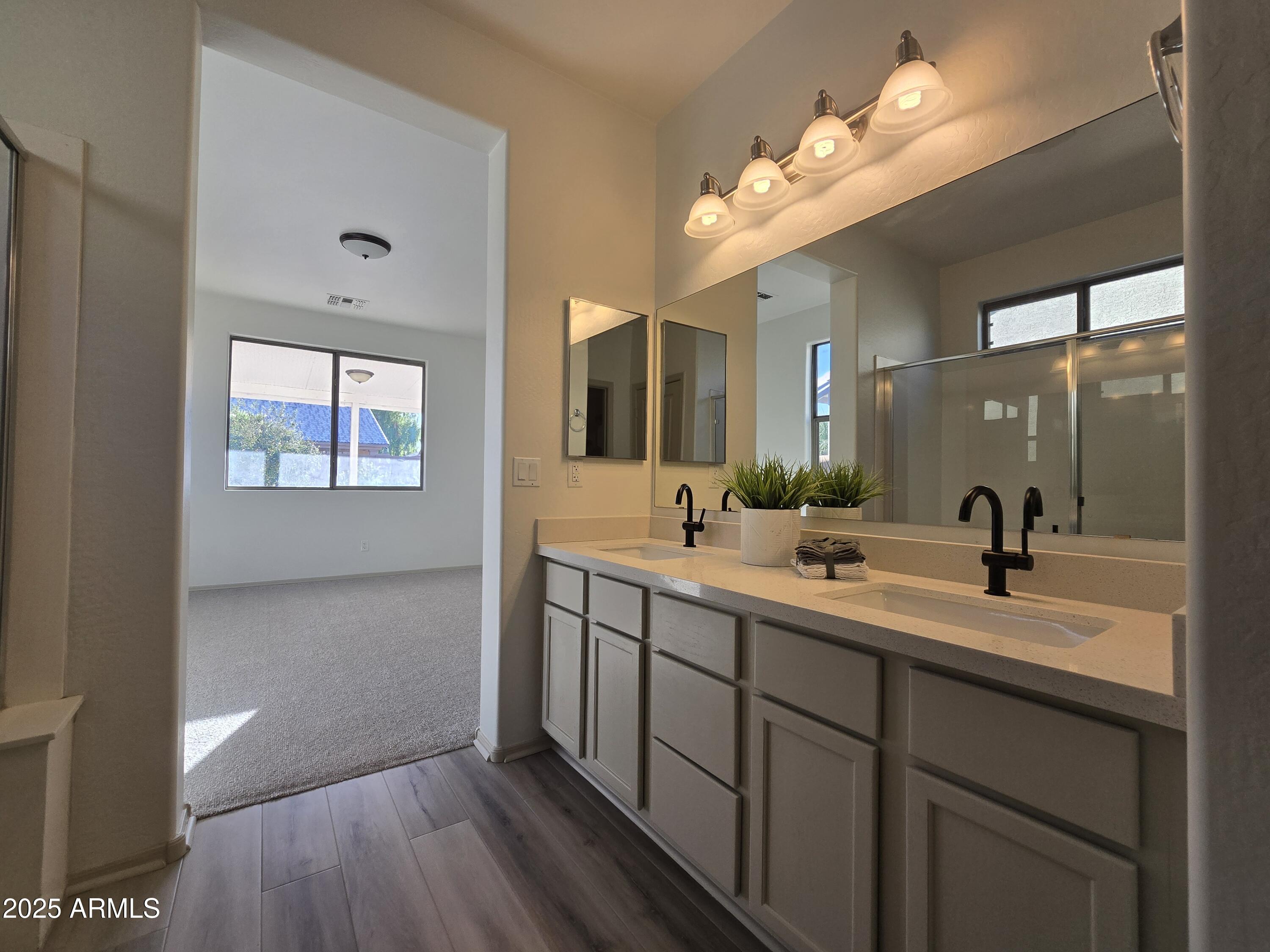 18196 Calacera Street Maricopa, AZ 85138 - Photo 14 of 21 a bathroom with a double vanity sink and a mirror