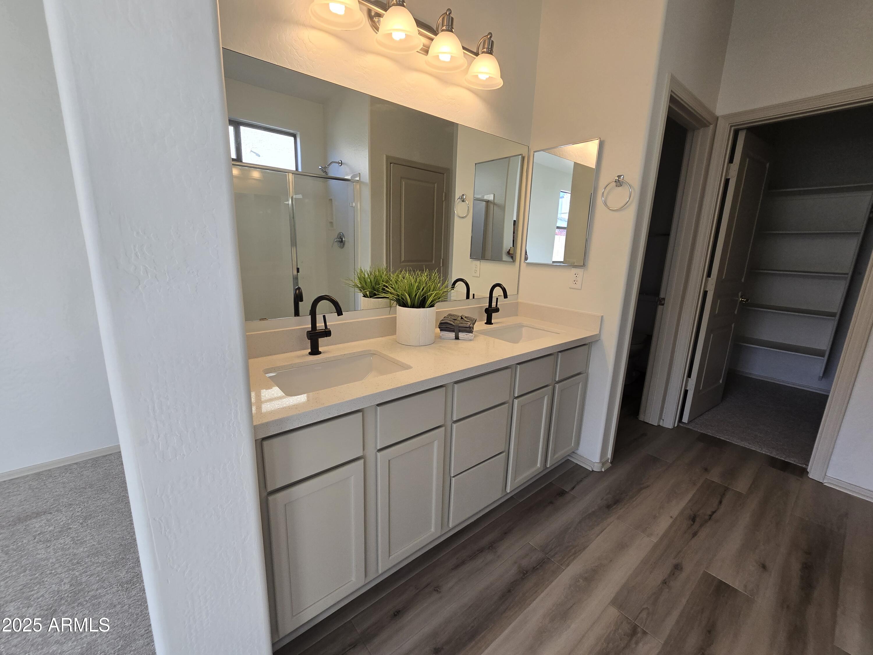18196 Calacera Street Maricopa, AZ 85138 - Photo 15 of 21 a bathroom with a double vanity sink and mirror