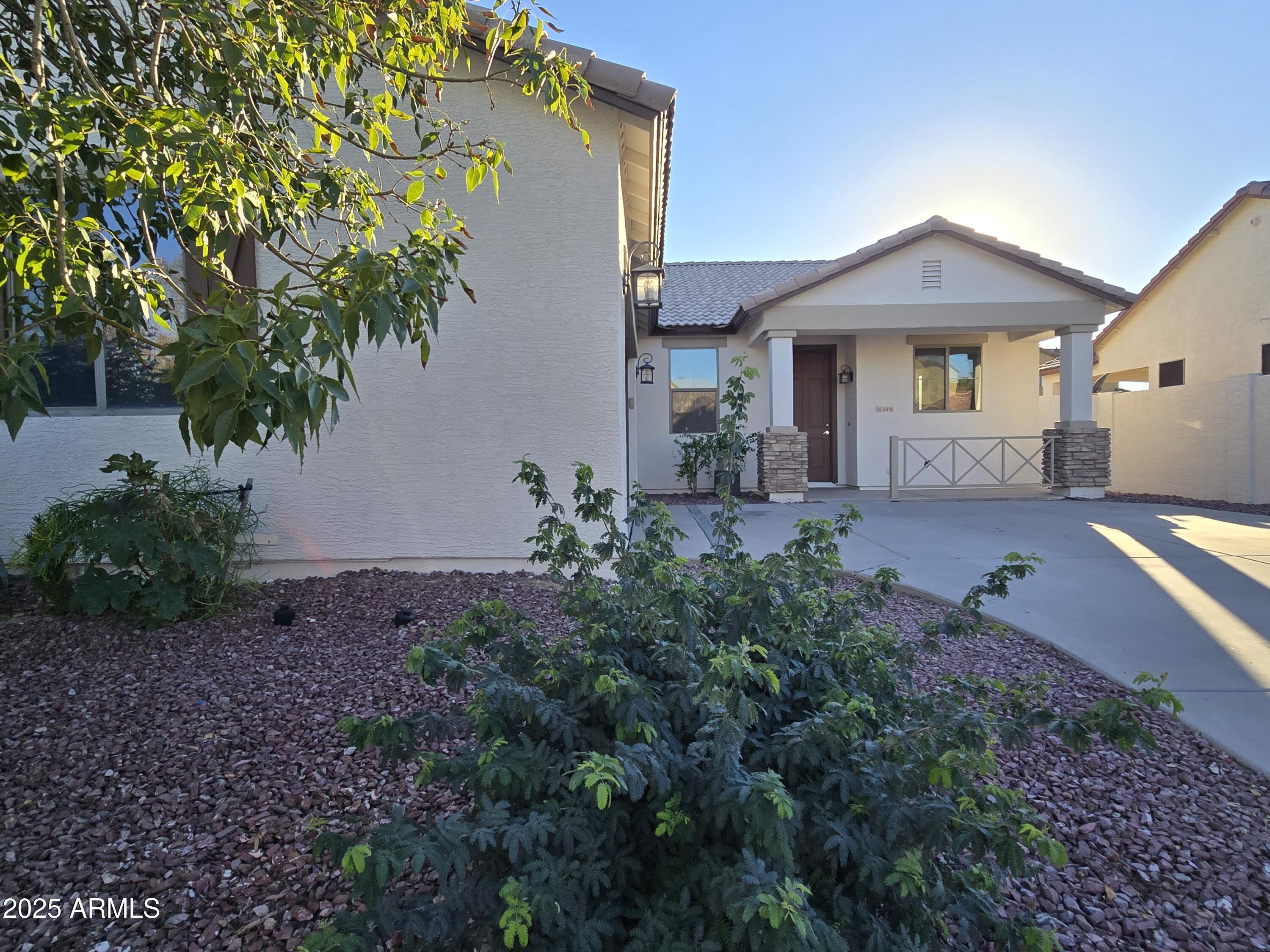 18196 Calacera Street Maricopa, AZ 85138 - Photo 2 of 21 a front view of a house with garden