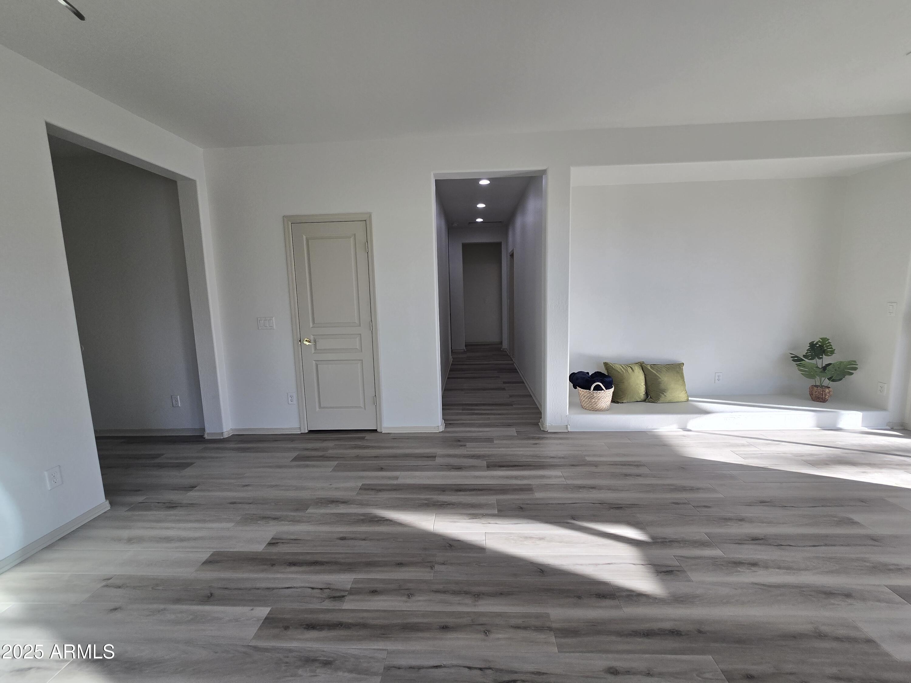 18196 Calacera Street Maricopa, AZ 85138 - Photo 6 of 21 a view of a livingroom with wooden floor and closet