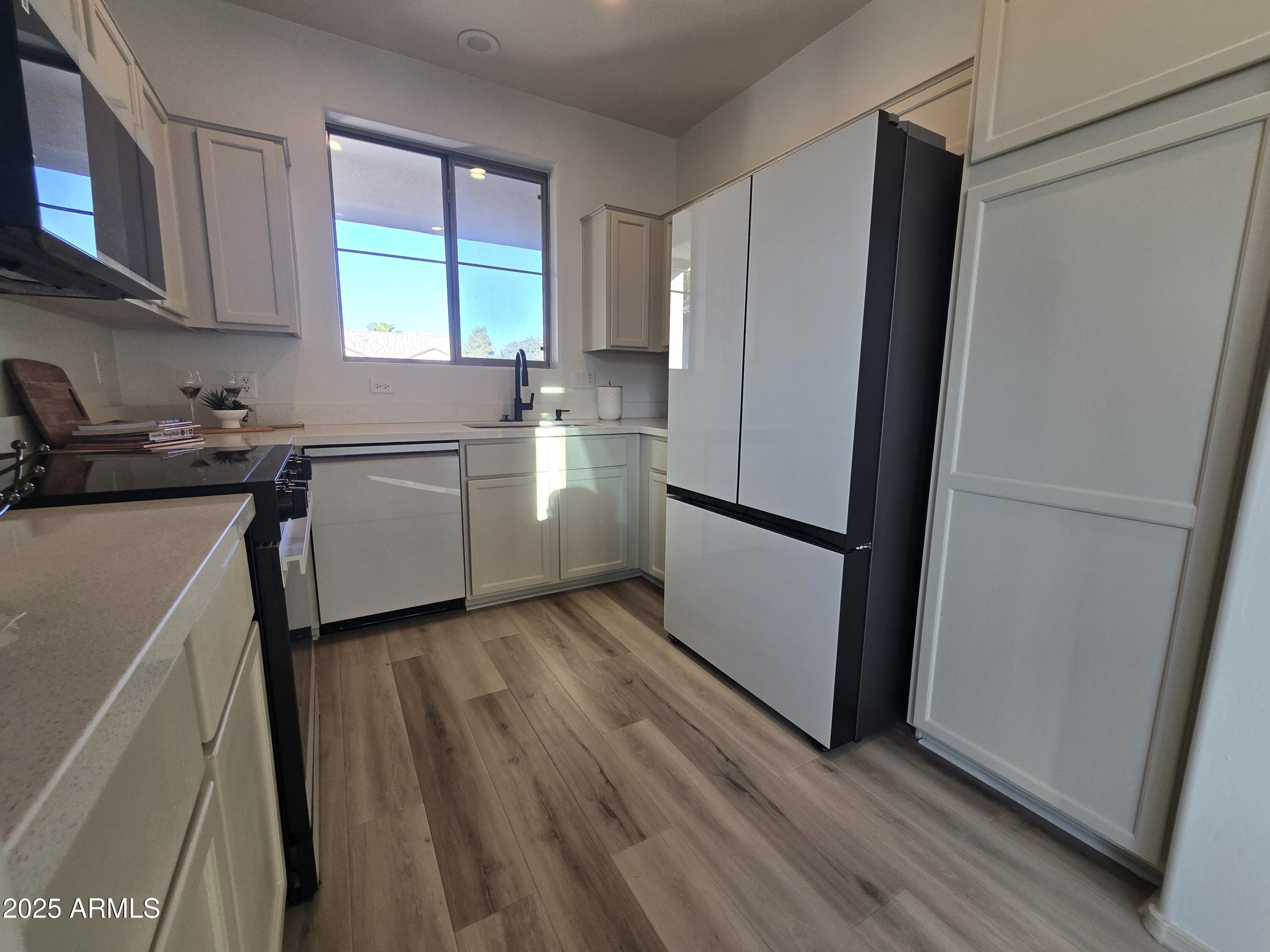 18196 Calacera Street Maricopa, AZ 85138 - Photo 8 of 21 a kitchen with a refrigerator and a sink