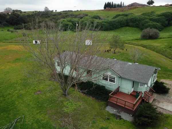 an aerial view of ocean with residential houses with outdoor space