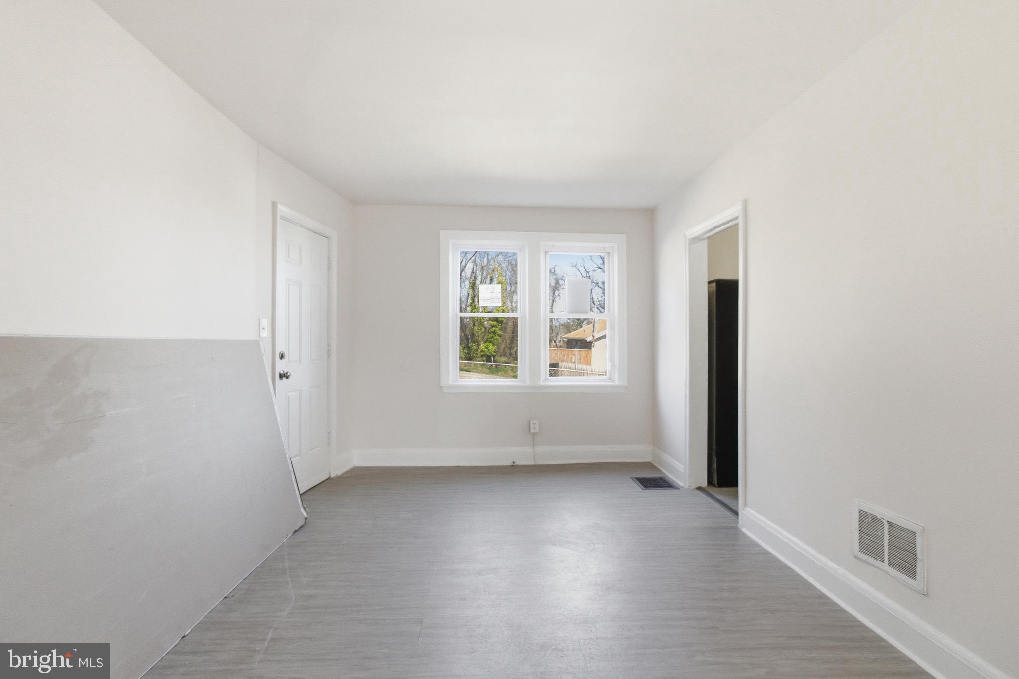 1509 Filbert Street Curtis Bay, MD 21226 - Photo 14 of 30 an empty room with wooden floor and windows
