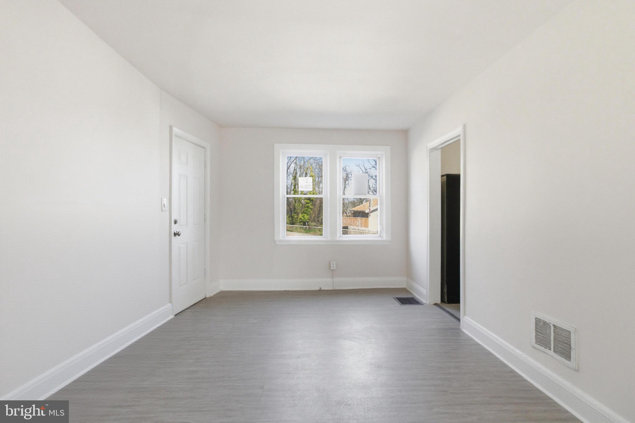 1509 Filbert Street Curtis Bay, MD 21226 - Photo 17 of 30 an empty room with wooden floor and windows