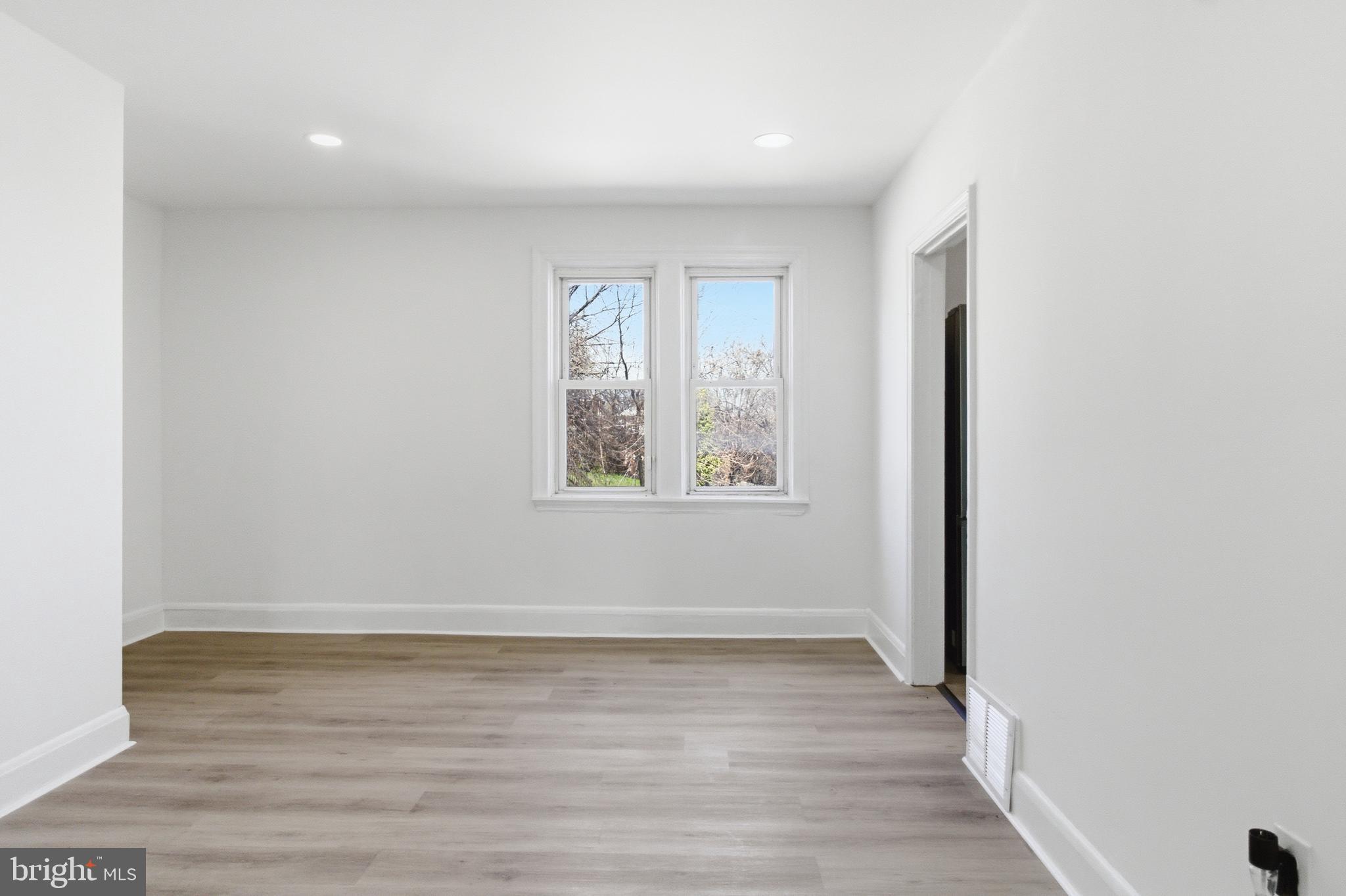 1509 Filbert Street Curtis Bay, MD 21226 - Photo 20 of 30 an empty room with wooden floor and windows