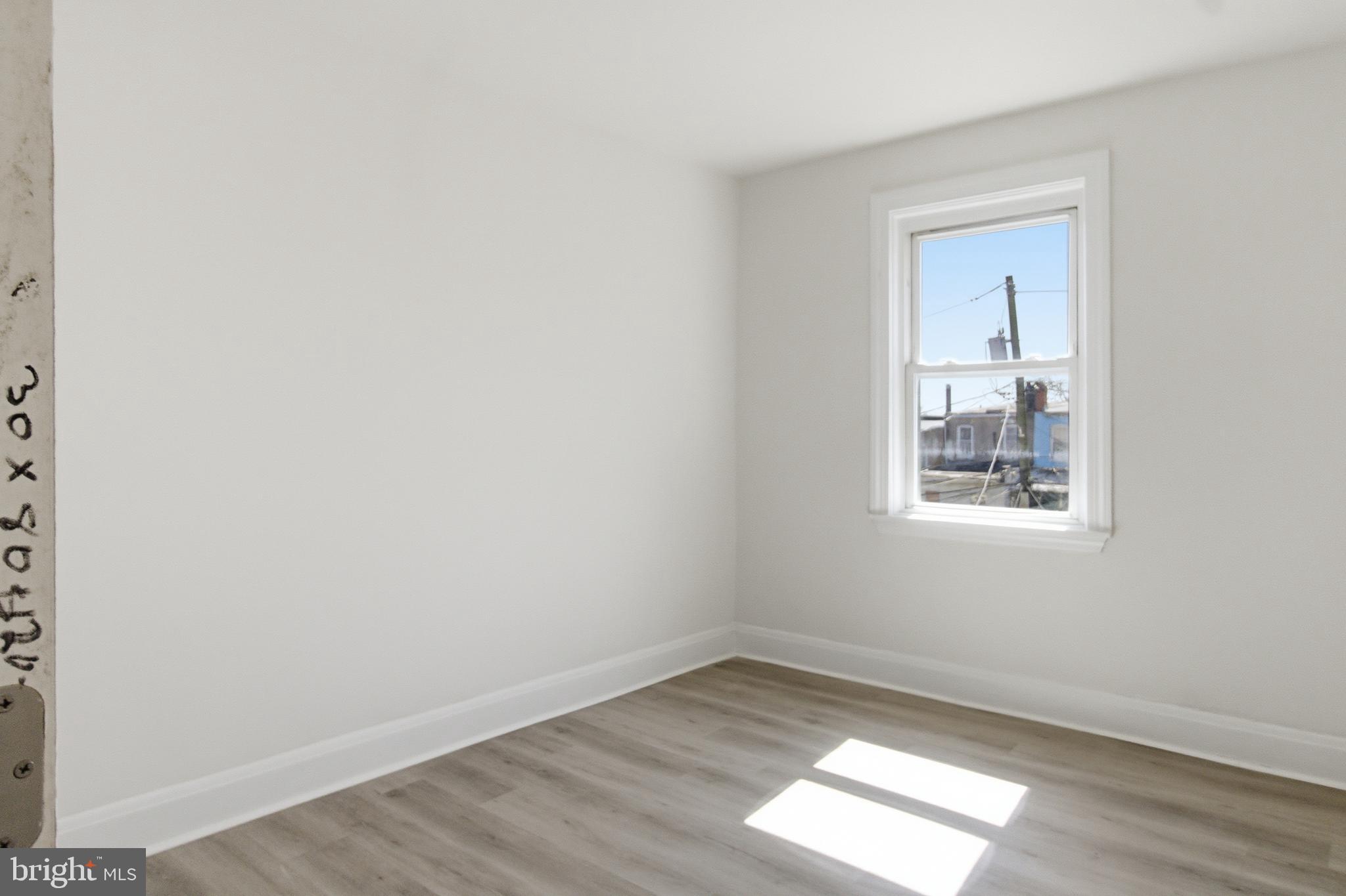 1509 Filbert Street Curtis Bay, MD 21226 - Photo 22 of 30 an empty room with wooden floor and windows