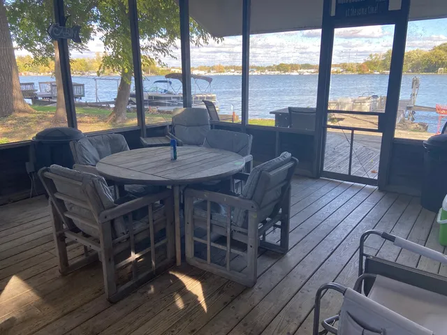 a view of a patio with wooden floor and outdoor seating
