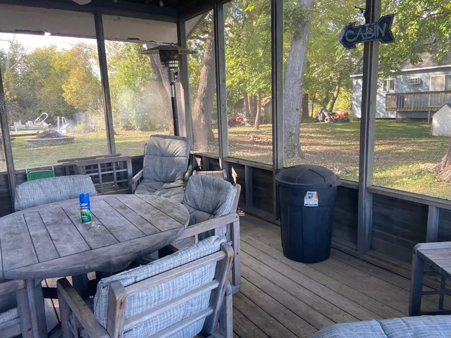 a view of a dining room with furniture large windows and wooden floor