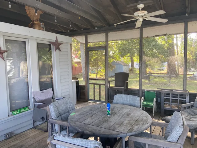 a dining room with furniture a chandelier and wooden floor