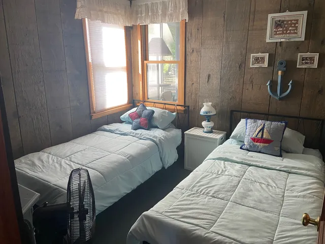 a bedroom with two beds and a window
