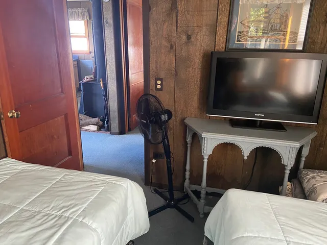 a bedroom with a bed and tv