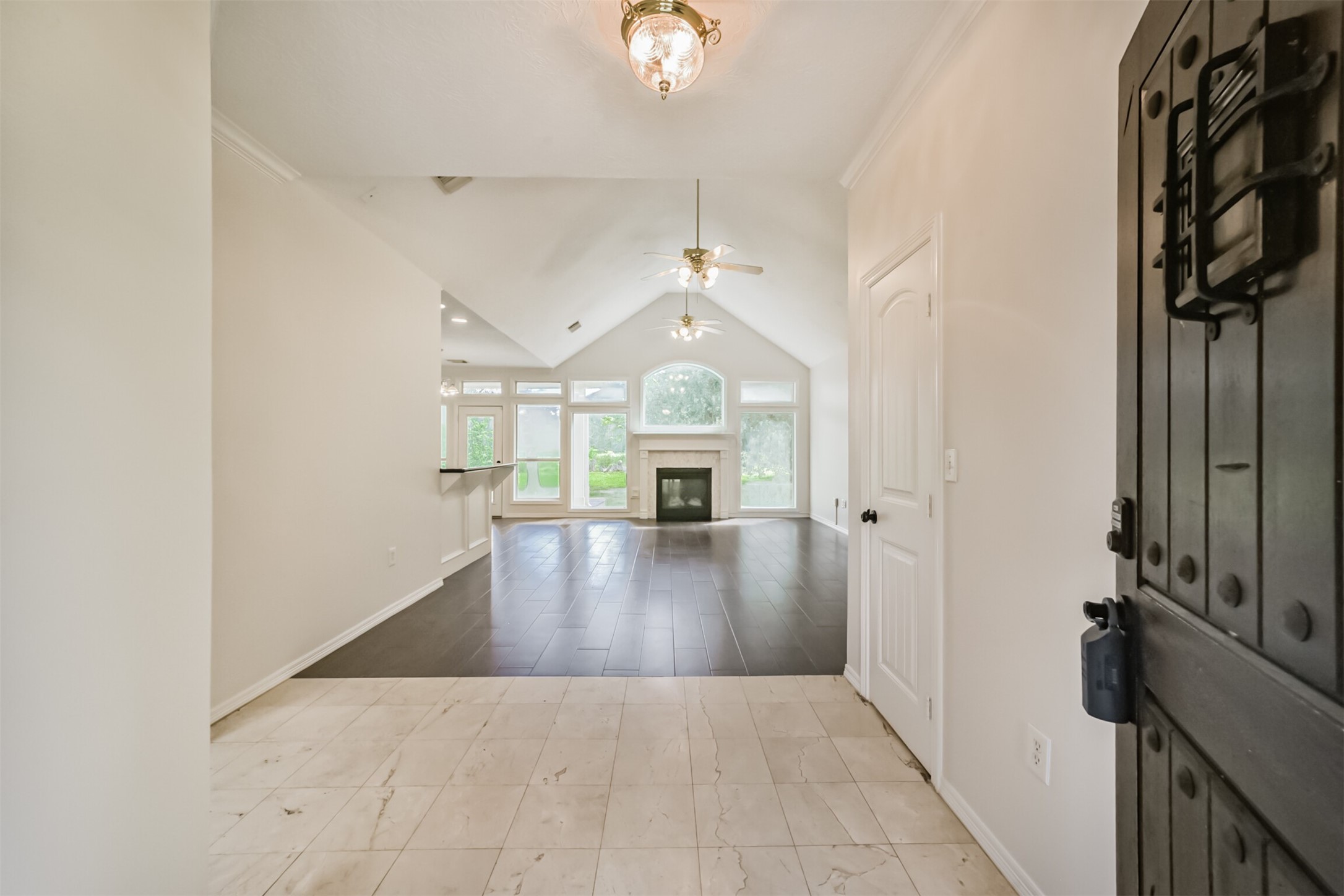 27322 Afton Way Huffman, TX 77336 - Photo 10 of 50 Welcoming entryway opens into a light-filled interior with soaring ceilings, elegant tile flooring, and stunning backyard sightlines.