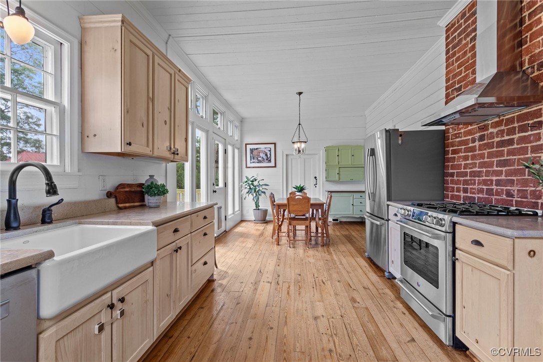 9341 Varina Road Henrico, VA 23231 - Photo 16 of 48 a kitchen with stainless steel appliances granite countertop a stove top oven a sink dishwasher a dining table and chairs with wooden floor