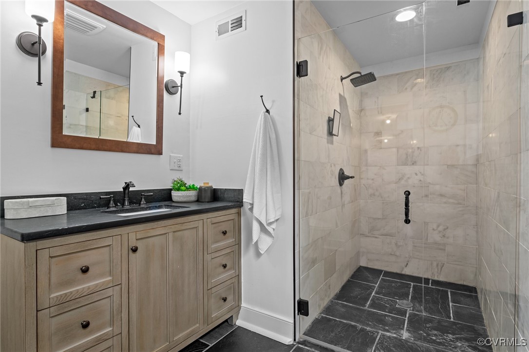9341 Varina Road Henrico, VA 23231 - Photo 38 of 48 a bathroom with a granite countertop sink a mirror a and a shower