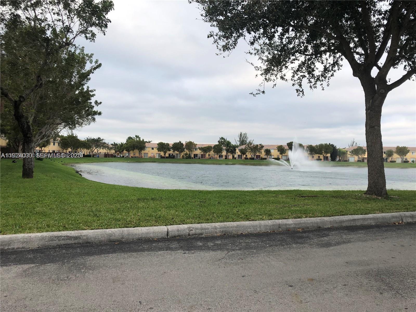 1692 Southeast 29th Court, Unit 206 Homestead, FL 33035 - Photo 1 of 15 a view of a park with large trees