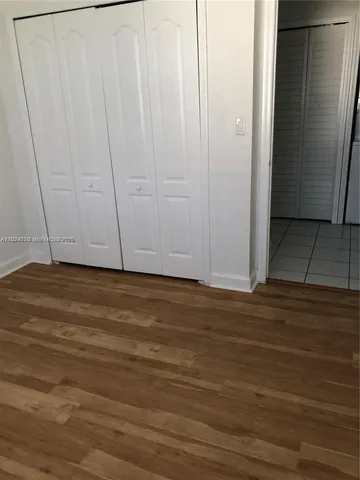 a view of room with wooden floor