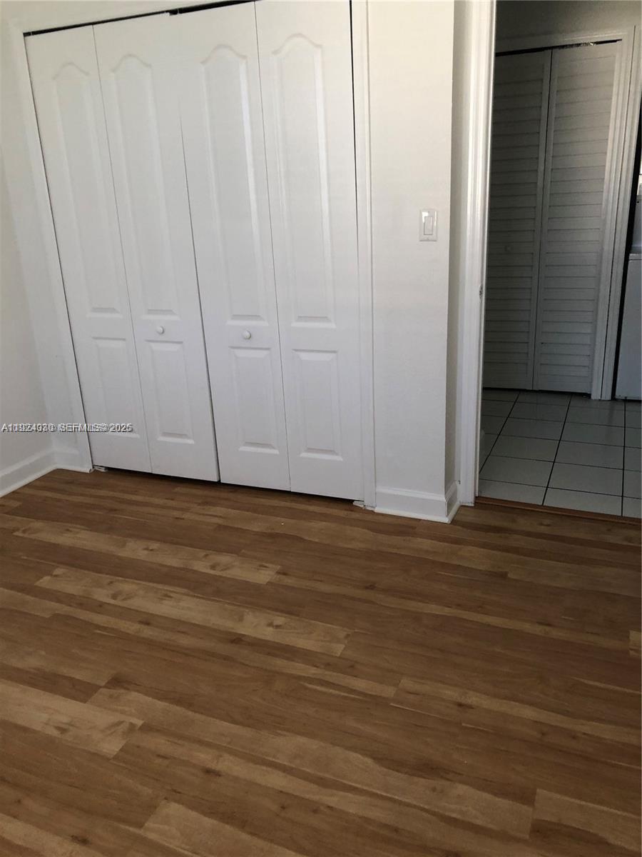 1692 Southeast 29th Court, Unit 206 Homestead, FL 33035 - Photo 3 of 15 a view of room with wooden floor