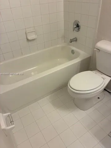 a bathroom with a toilet and a bathtub