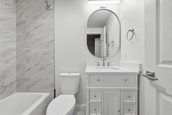 a bathroom with a sink a toilet and a bathtub