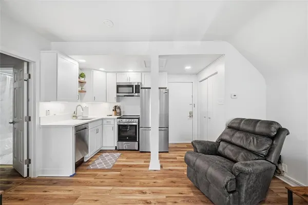 a kitchen with a refrigerator sink and cabinets