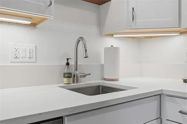 a close view of a sink a faucet and a shower in a kitchen