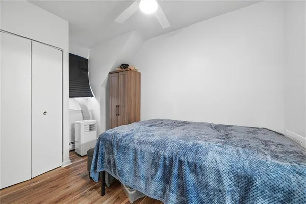 a bedroom with a bed and wooden floor
