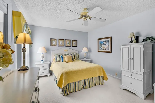 a bedroom with a bed and a lamp on table