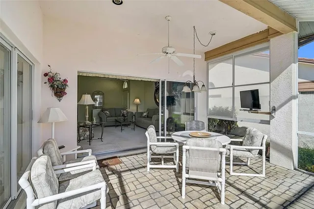 a dining room with furniture a chandelier and window